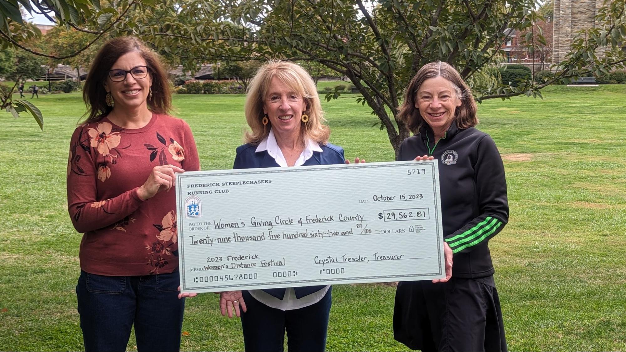 Left to Right, Michele Newton, President, Frederick Steeplechasers Running Club; Bonnie Swanson, Chair, Women's Giving Circle; Harriet Langlois, Race Director, Frederick Steeplechasers Running Club